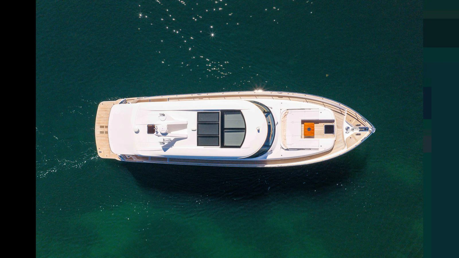 A sleek yacht is captured from above, showcasing its streamlined design and spacious deck areas. aboard LYRICA Yacht for Sale