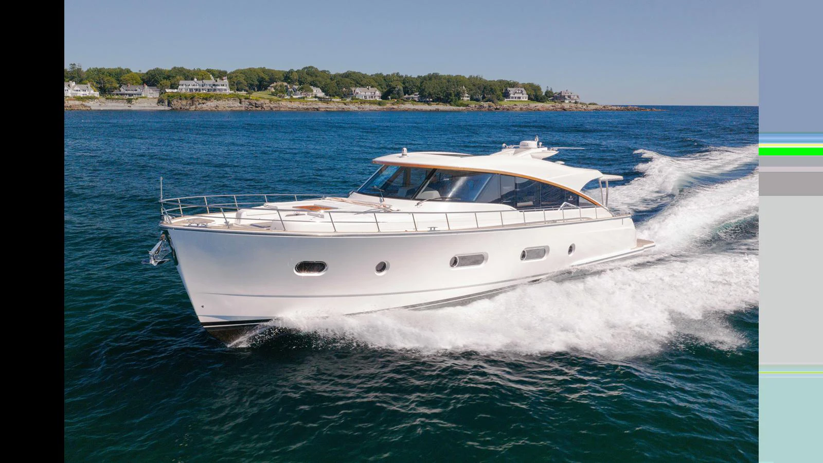 A sleek and modern yacht cruises swiftly through clear blue waters near a coastal town. aboard LYRICA Yacht for Sale