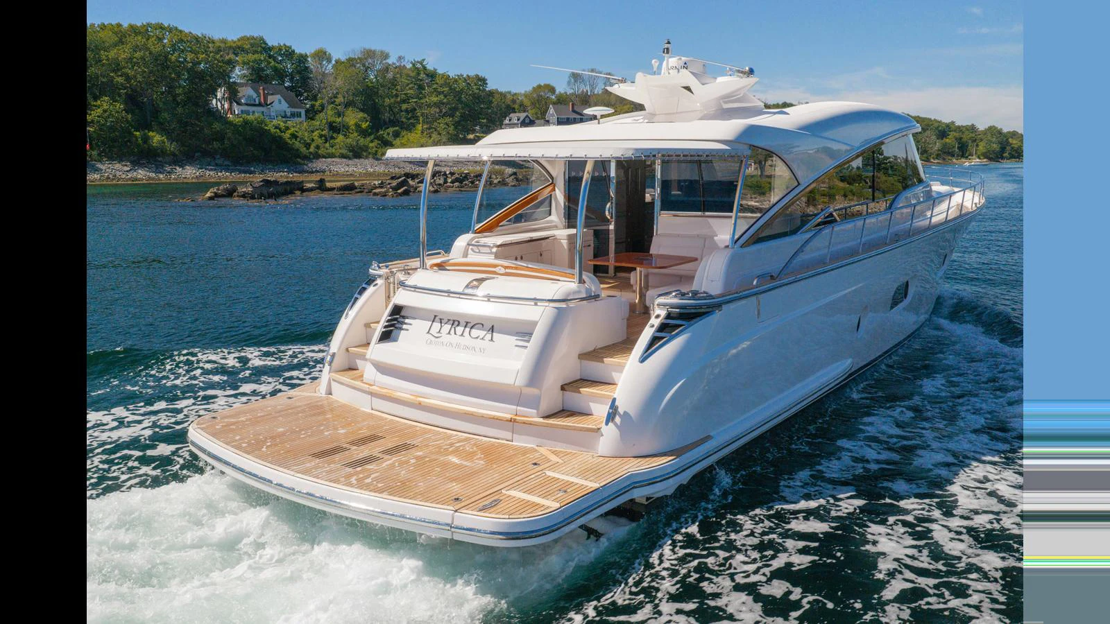 A sleek yacht cruises through clear waters, showcasing its elegant aft deck and modern design. aboard LYRICA Yacht for Sale