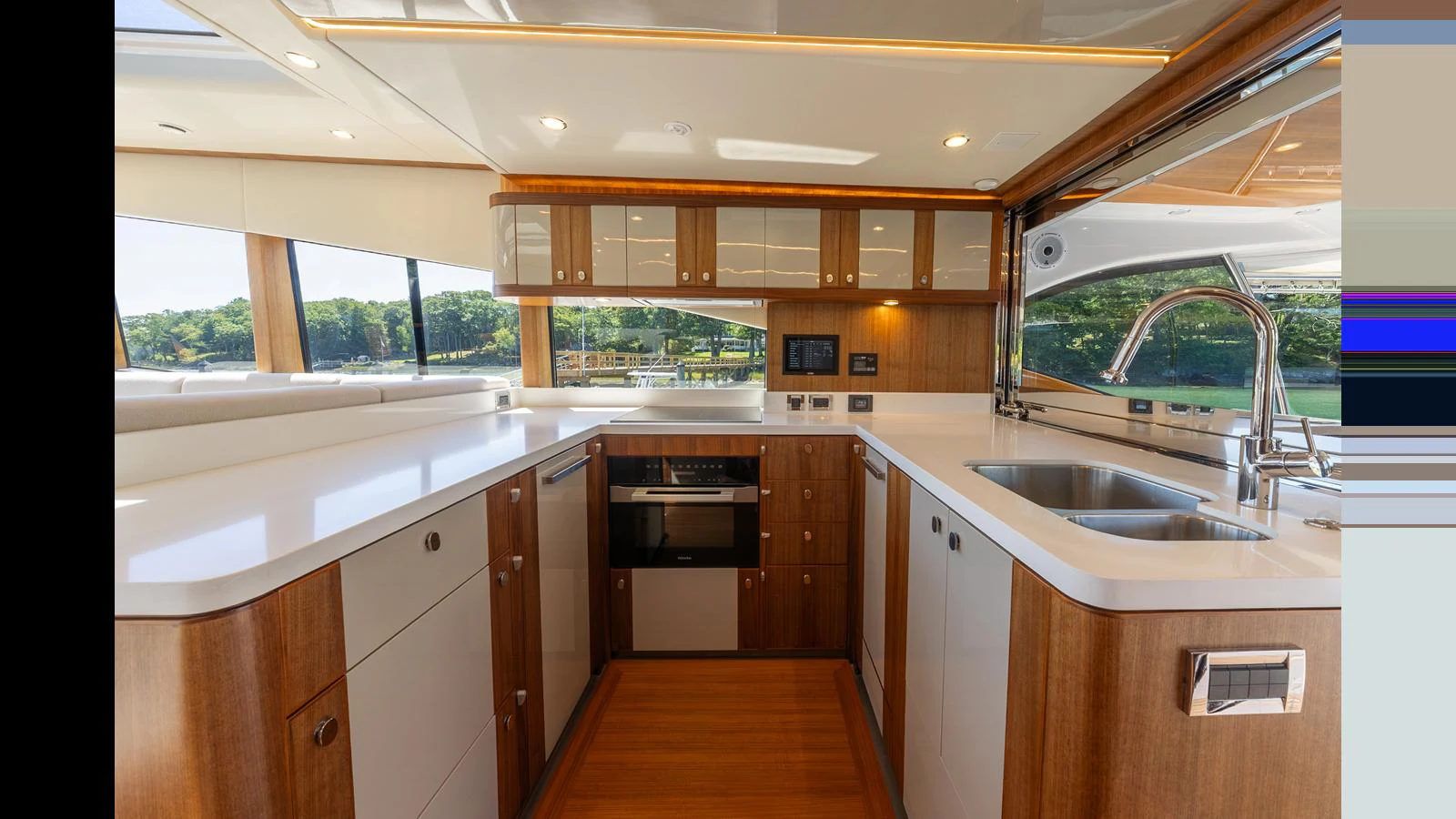 The yacht's galley features modern appliances and ample counter space with a view of the water. aboard LYRICA Yacht for Sale