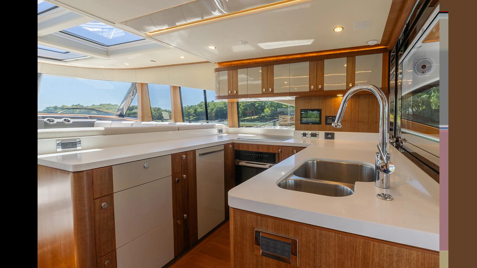 The galley features modern appliances and ample counter space with a scenic view through large windows. aboard LYRICA Yacht for Sale