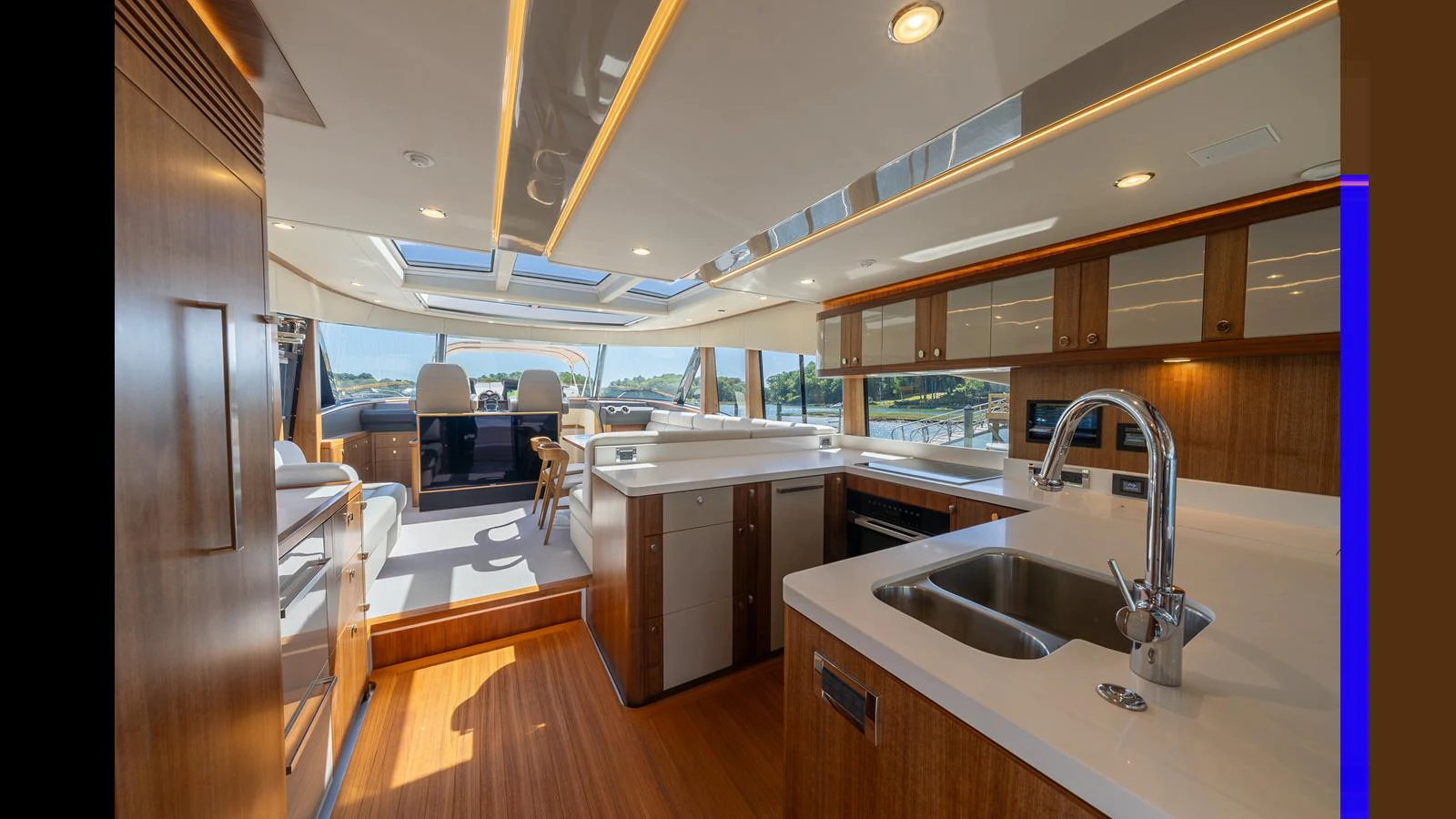The yacht's galley features modern appliances and ample counter space, seamlessly connected to the dining and lounging areas. aboard LYRICA Yacht for Sale