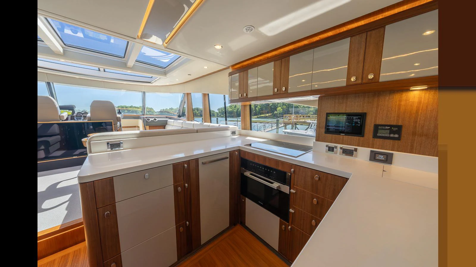 The yacht's galley features modern appliances and ample counter space, bathed in natural light from large windows. aboard LYRICA Yacht for Sale