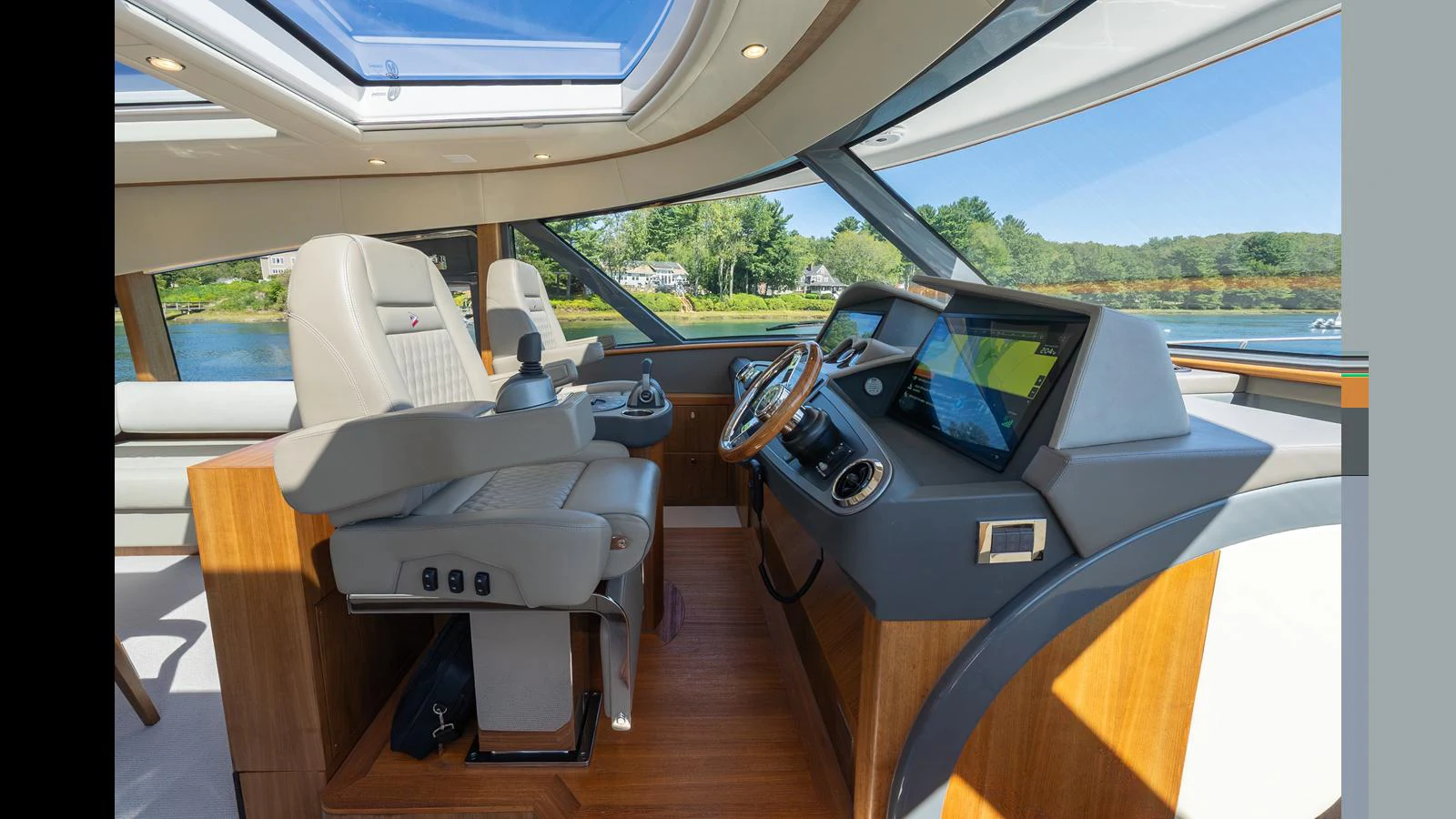 The helm station features modern navigation equipment and luxurious seating with a panoramic view. aboard LYRICA Yacht for Sale