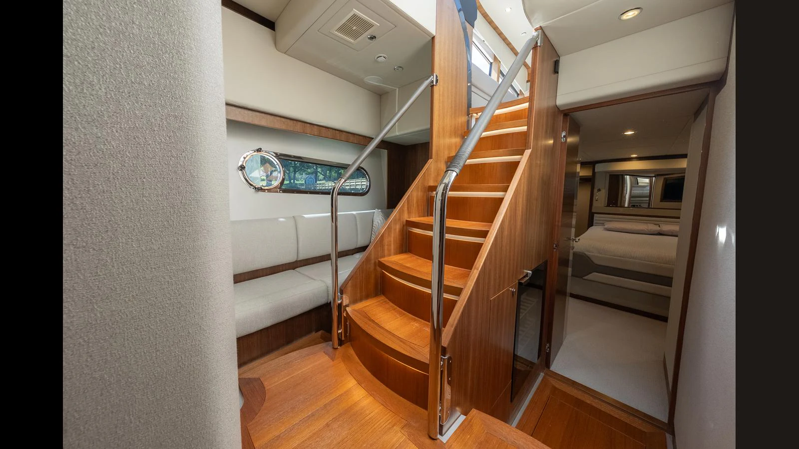 A beautifully crafted wooden staircase leads to the lower deck, showcasing the yacht's elegant interior design. aboard LYRICA Yacht for Sale