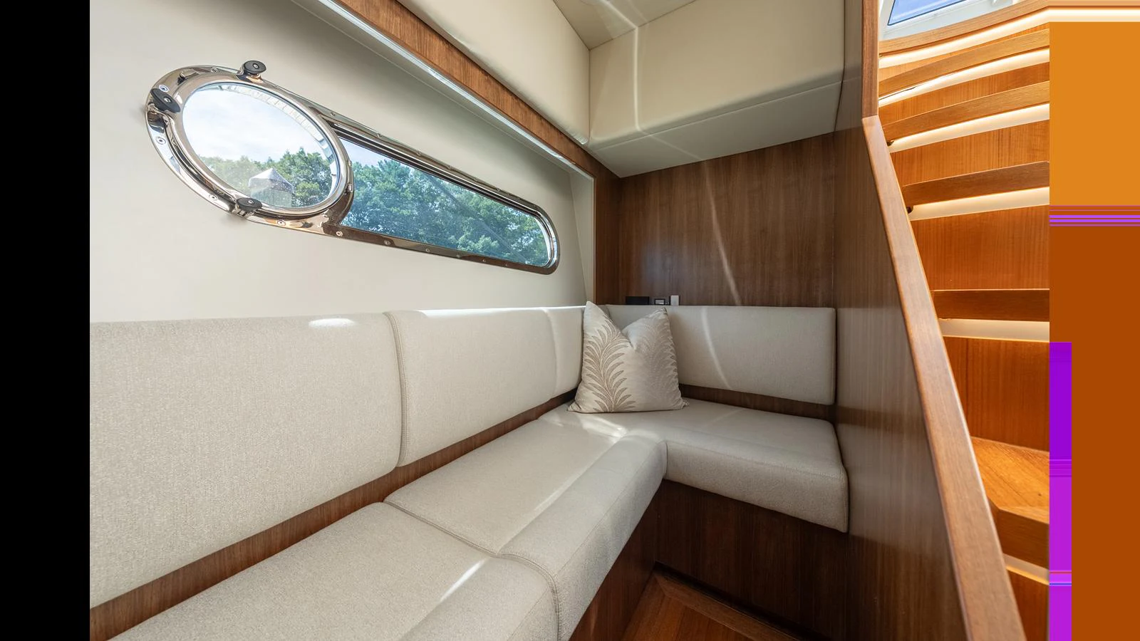 A cozy seating area with a window and wooden accents, perfect for relaxation. aboard LYRICA Yacht for Sale