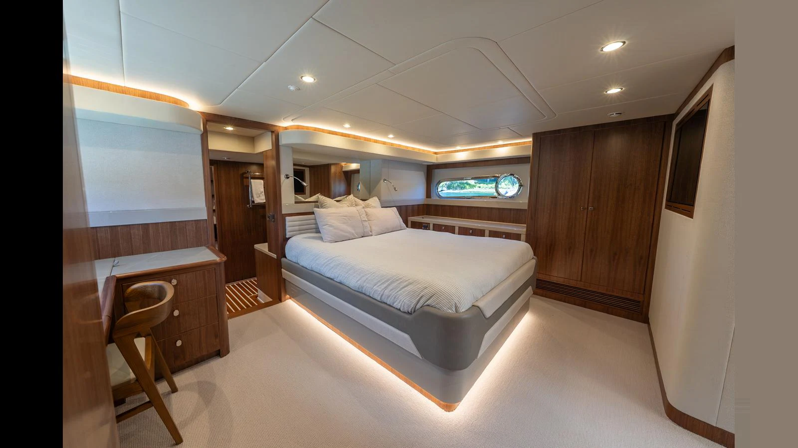 The master stateroom features a spacious bed, elegant wood finishes, and ample natural light. aboard LYRICA Yacht for Sale
