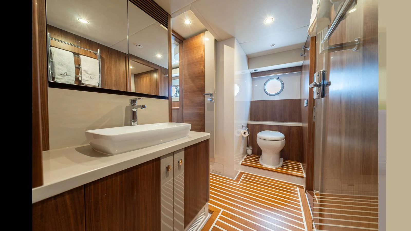 The yacht's bathroom features modern fixtures and elegant wood paneling. aboard LYRICA Yacht for Sale