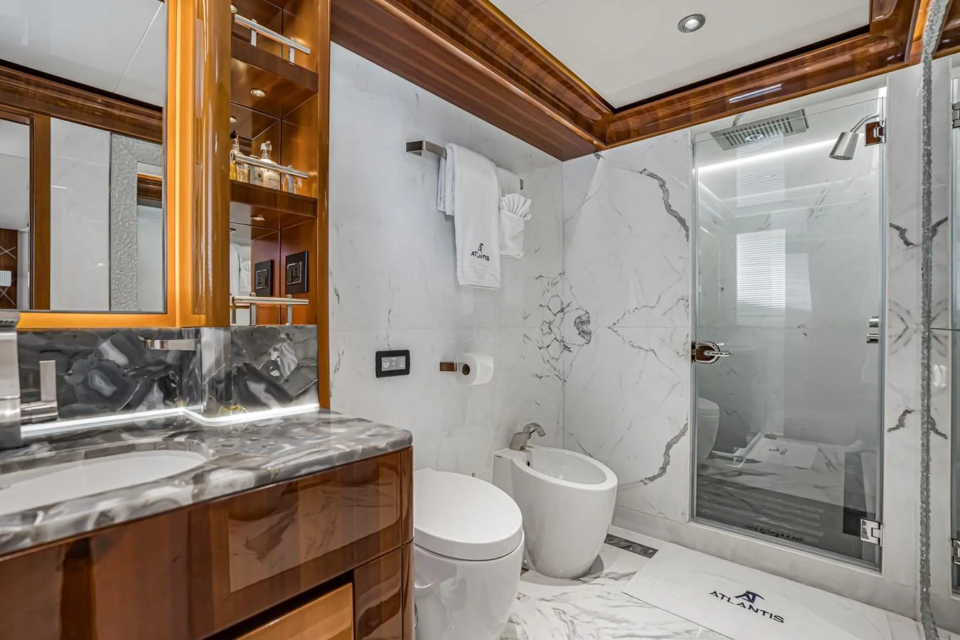 The luxurious bathroom features elegant marble surfaces and modern fixtures. aboard ATLANTIS Yacht for Sale