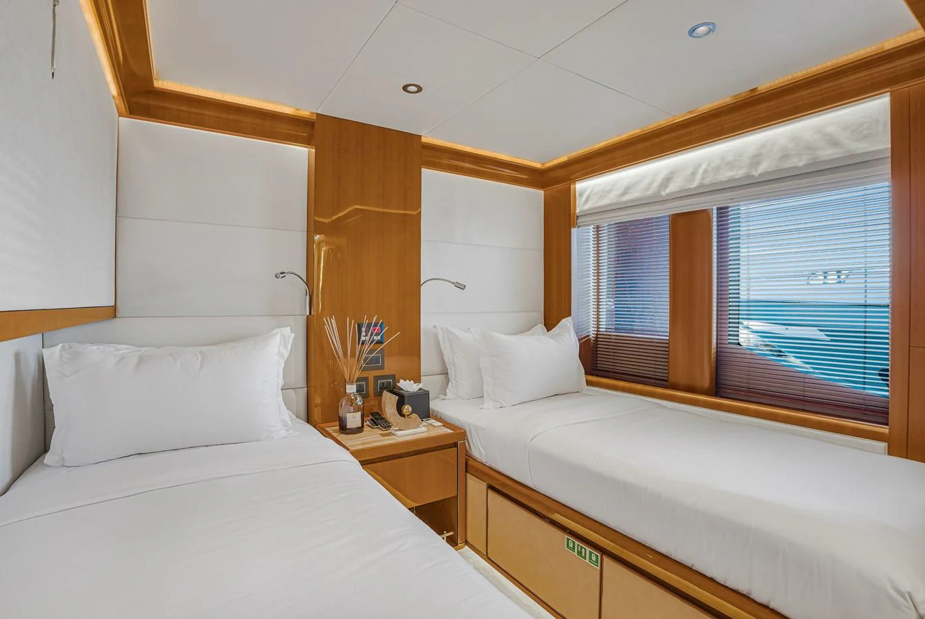 The twin stateroom offers a cozy and inviting space with two single beds and a view of the sea. aboard ATLANTIS Yacht for Sale