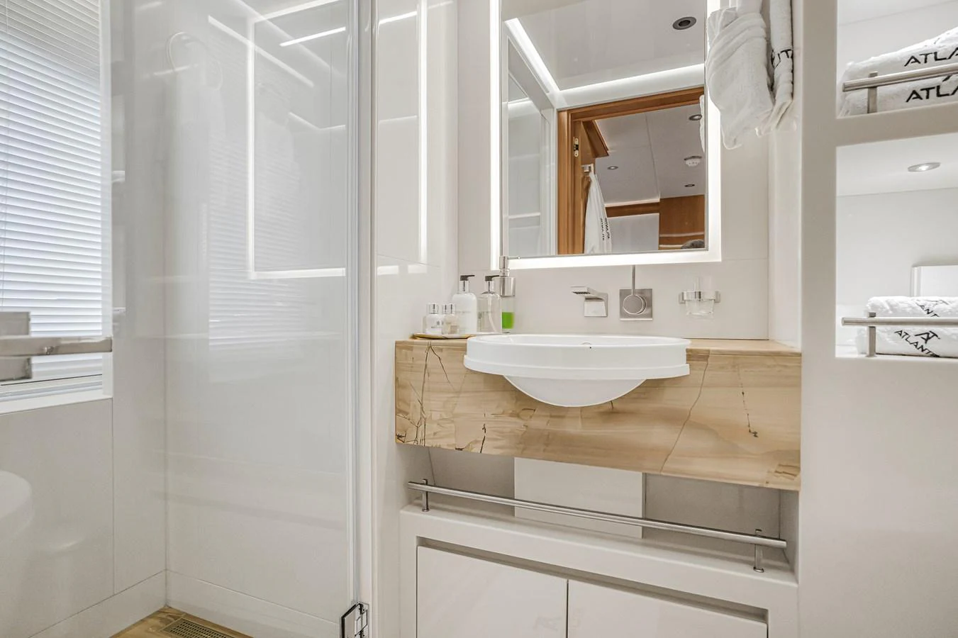 A pristine yacht bathroom featuring modern fixtures and elegant design. aboard ATLANTIS Yacht for Sale