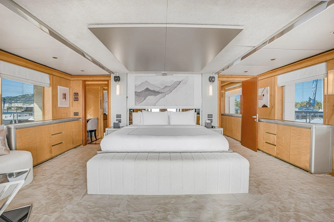 The master stateroom features a spacious bed with elegant decor and ample natural light. aboard ATLANTIS Yacht for Sale