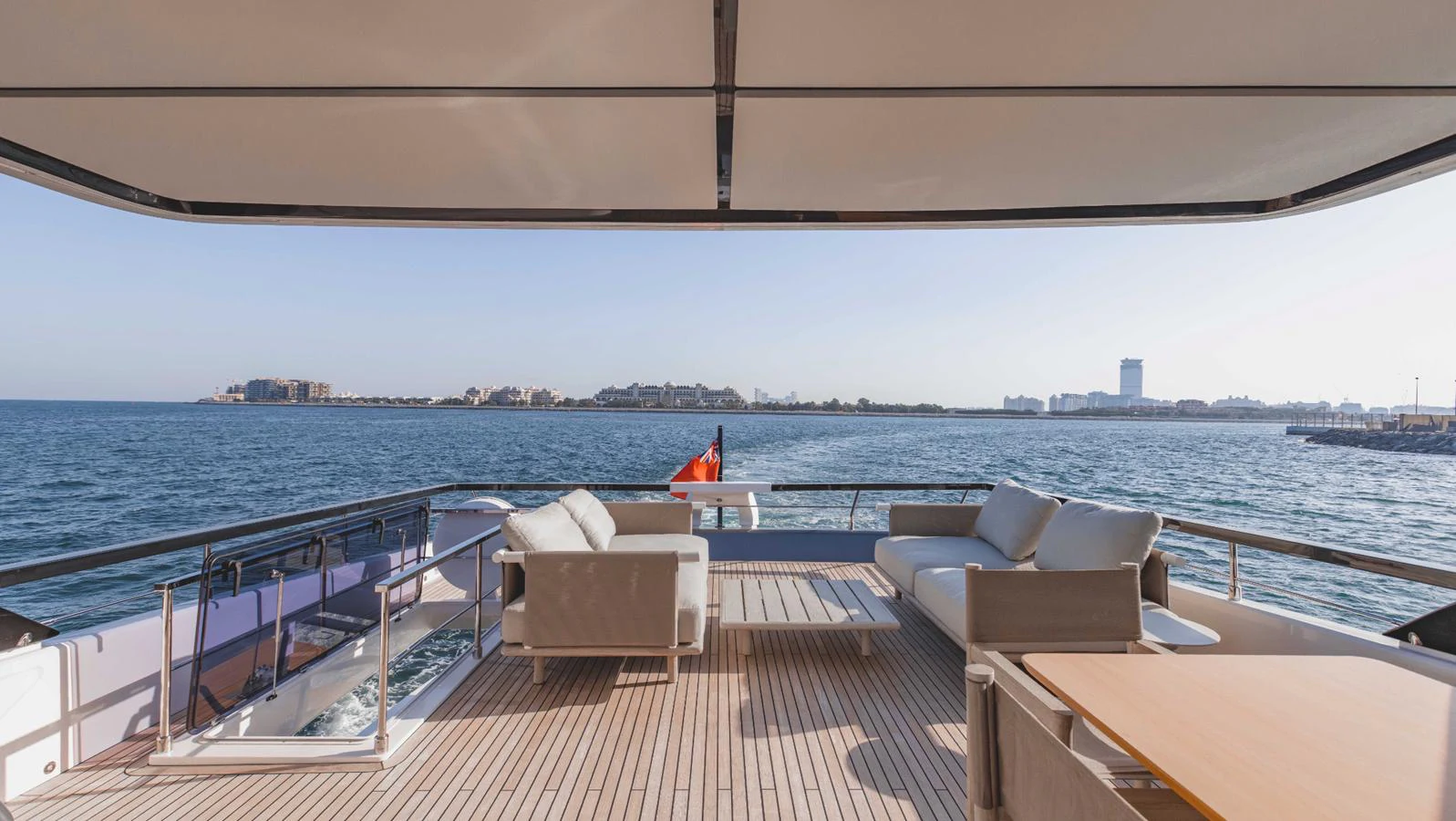 The aft deck offers a spacious and inviting area with comfortable seating and stunning views of the water. aboard AMANI Yacht for Sale