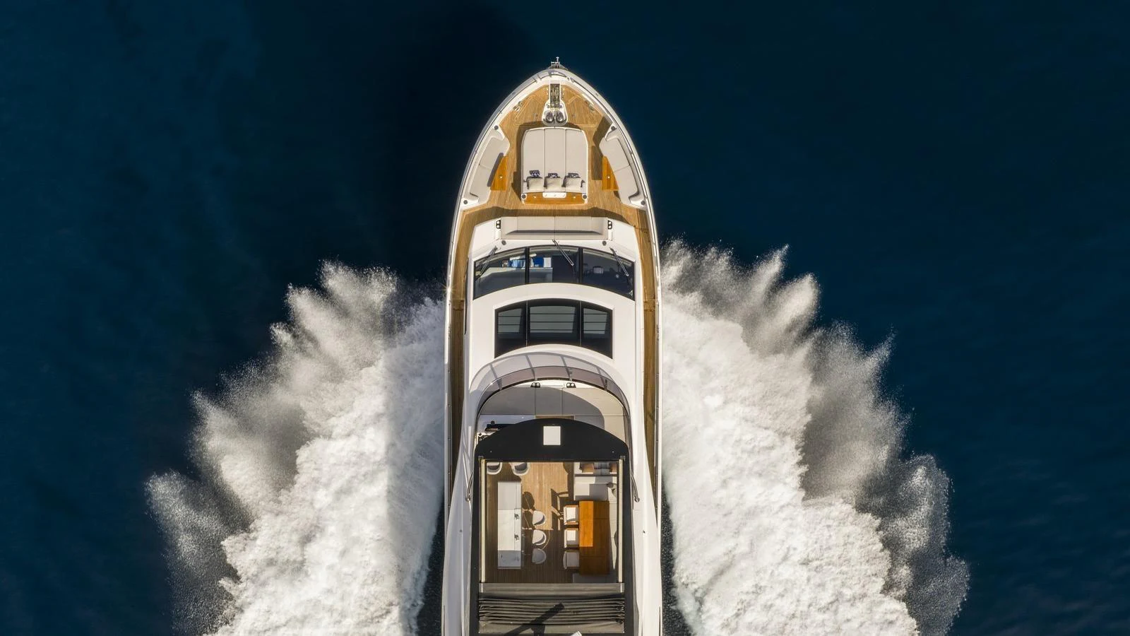 A sleek yacht cuts through the water, showcasing its elegant design from an aerial perspective. aboard W OF JERSEY Yacht for Sale
