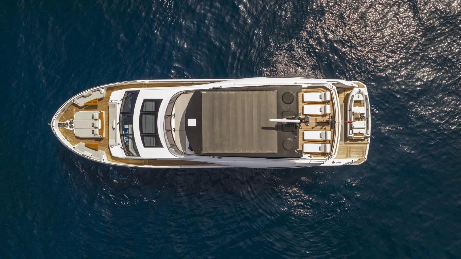 An aerial view of a luxurious yacht cruising on calm blue waters. aboard W OF JERSEY Yacht for Sale