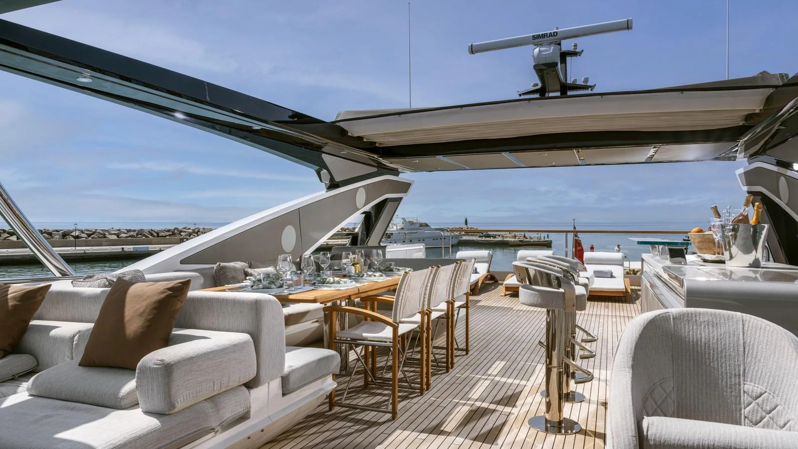 The aft deck features a spacious dining area and comfortable seating with a stunning view of the water. aboard W OF JERSEY Yacht for Sale