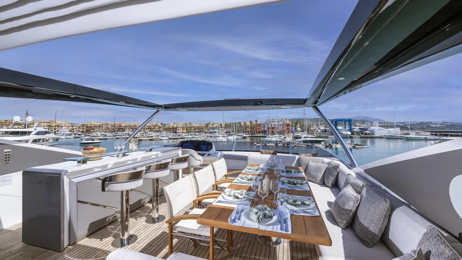 The flybridge features an elegant dining area with panoramic views of the marina. aboard W OF JERSEY Yacht for Sale