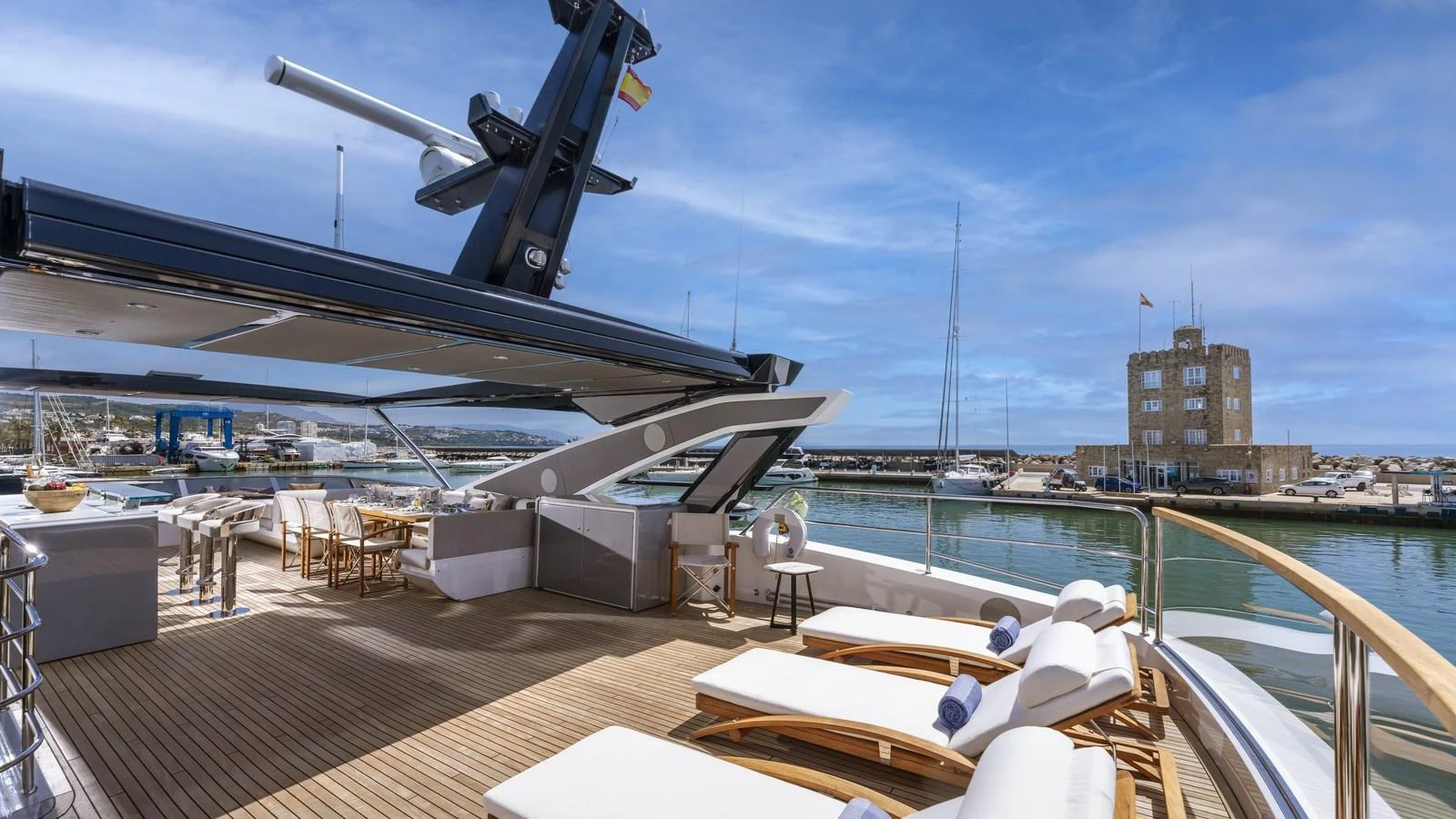 The aft deck offers a luxurious outdoor lounging area with sunbeds and a dining space, perfect for relaxation and socializing. aboard W OF JERSEY Yacht for Sale