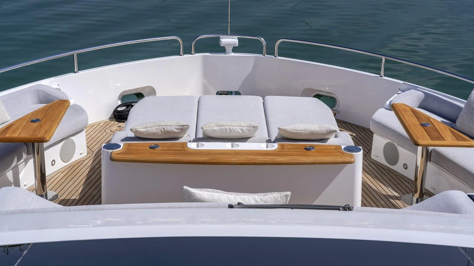 The foredeck features luxurious sun pads and comfortable seating areas with wooden accents, perfect for relaxation. aboard W OF JERSEY Yacht for Sale