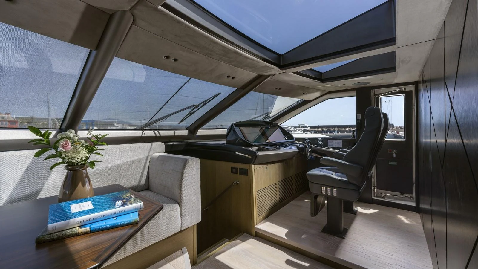 The helm area features a sleek design with a large skylight and comfortable seating. aboard W OF JERSEY Yacht for Sale