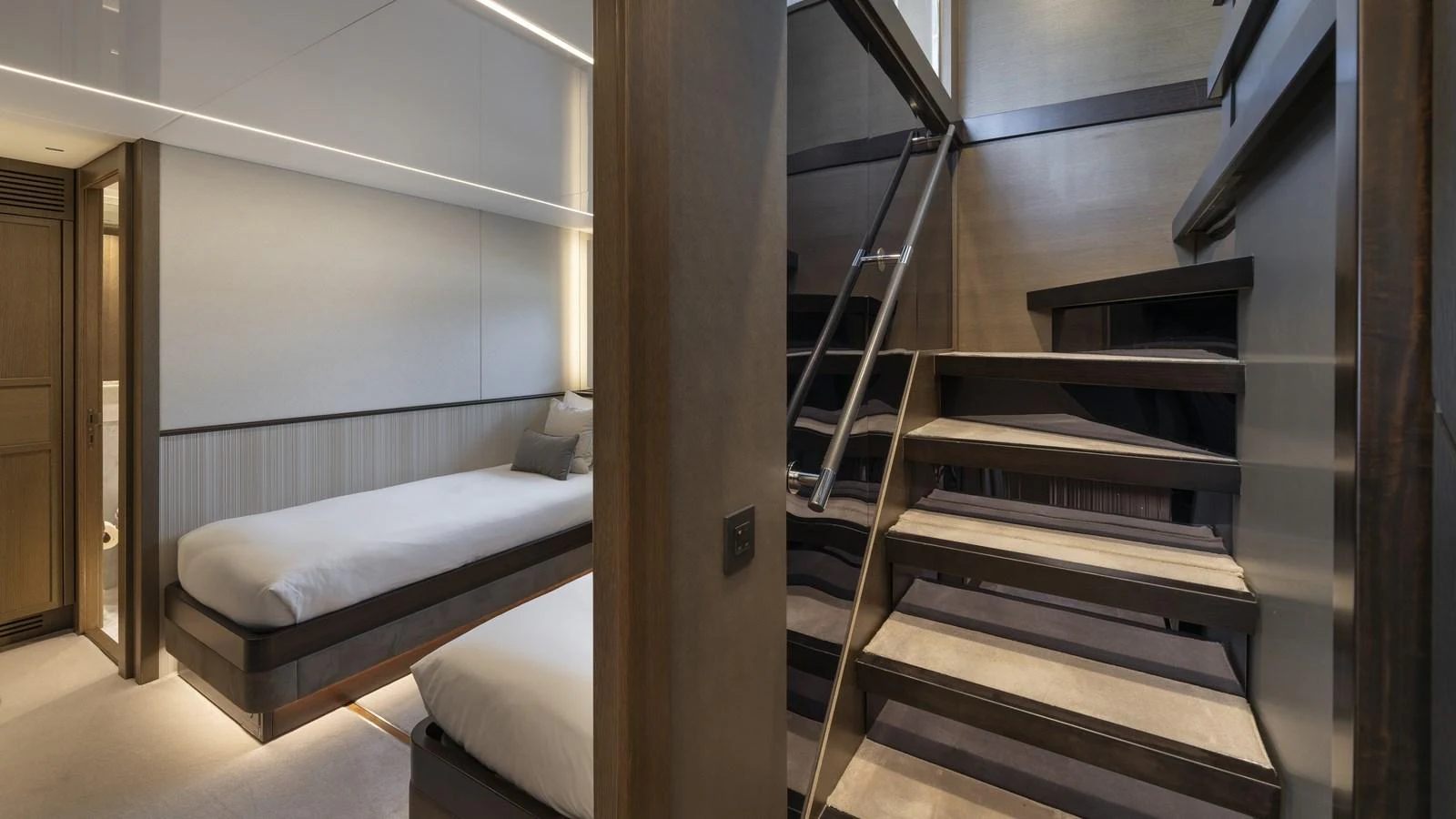 The guest cabin features twin beds and a modern staircase leading to the upper deck. aboard W OF JERSEY Yacht for Sale