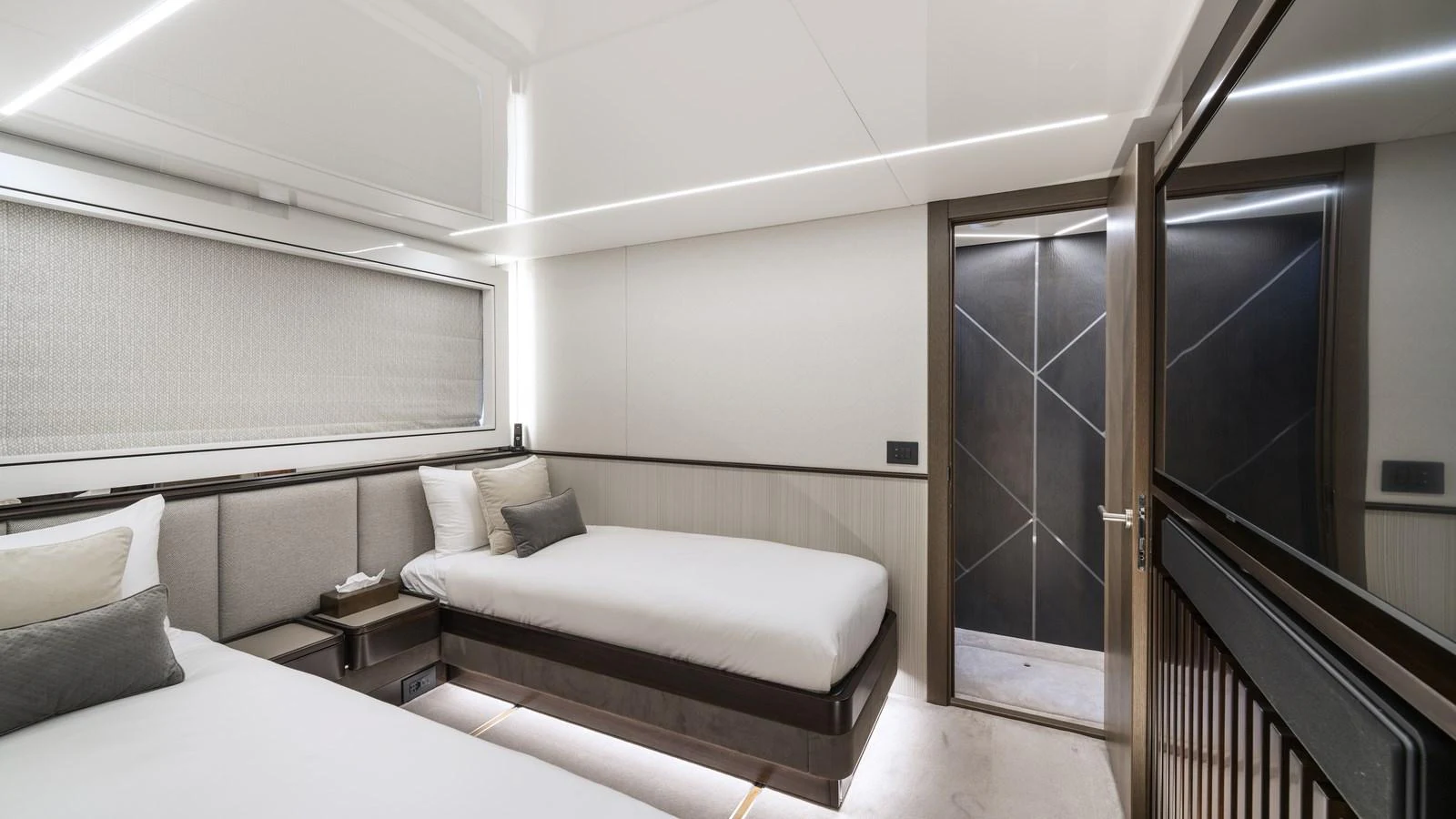 The guest stateroom features two comfortable beds with modern decor and ample lighting. aboard W OF JERSEY Yacht for Sale