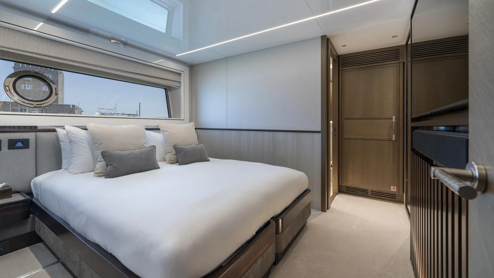 The stateroom features a luxurious bed with ample natural light from the large window and skylight. aboard W OF JERSEY Yacht for Sale
