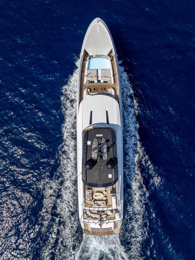An aerial view of a luxurious yacht cruising through deep blue waters, showcasing its sleek design and spacious decks. aboard TOY Yacht for Sale