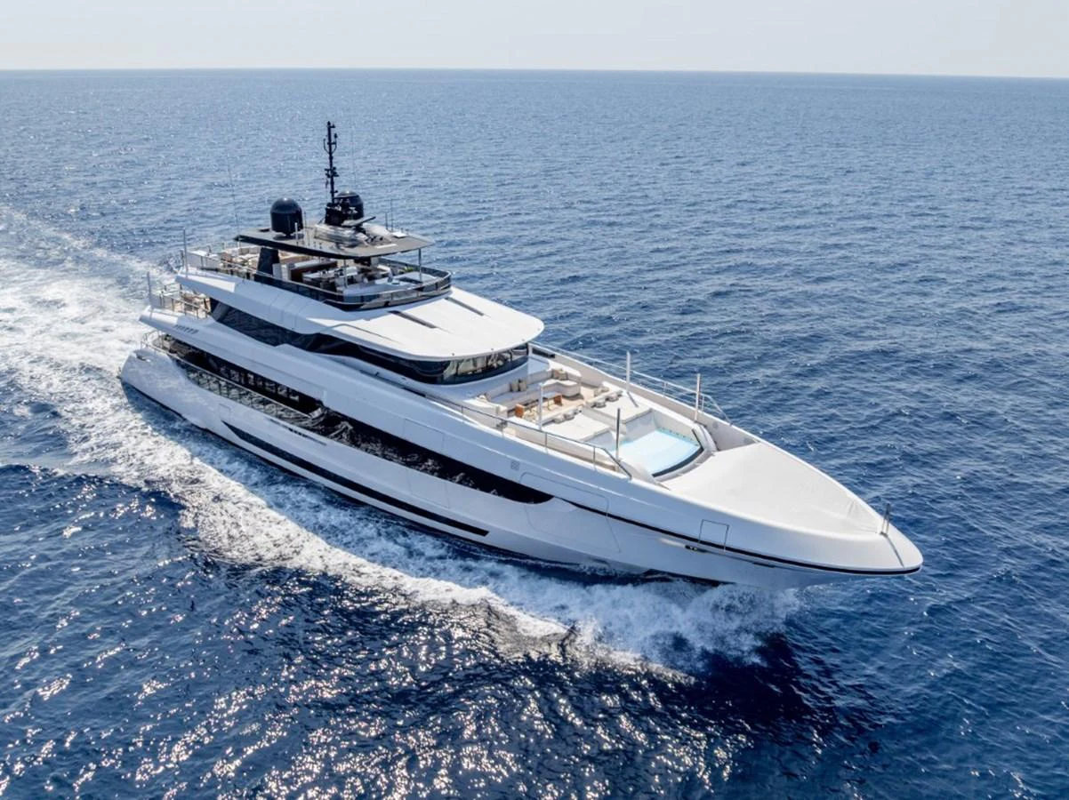 A sleek and modern yacht cruising on the open sea under clear skies. aboard TOY Yacht for Sale
