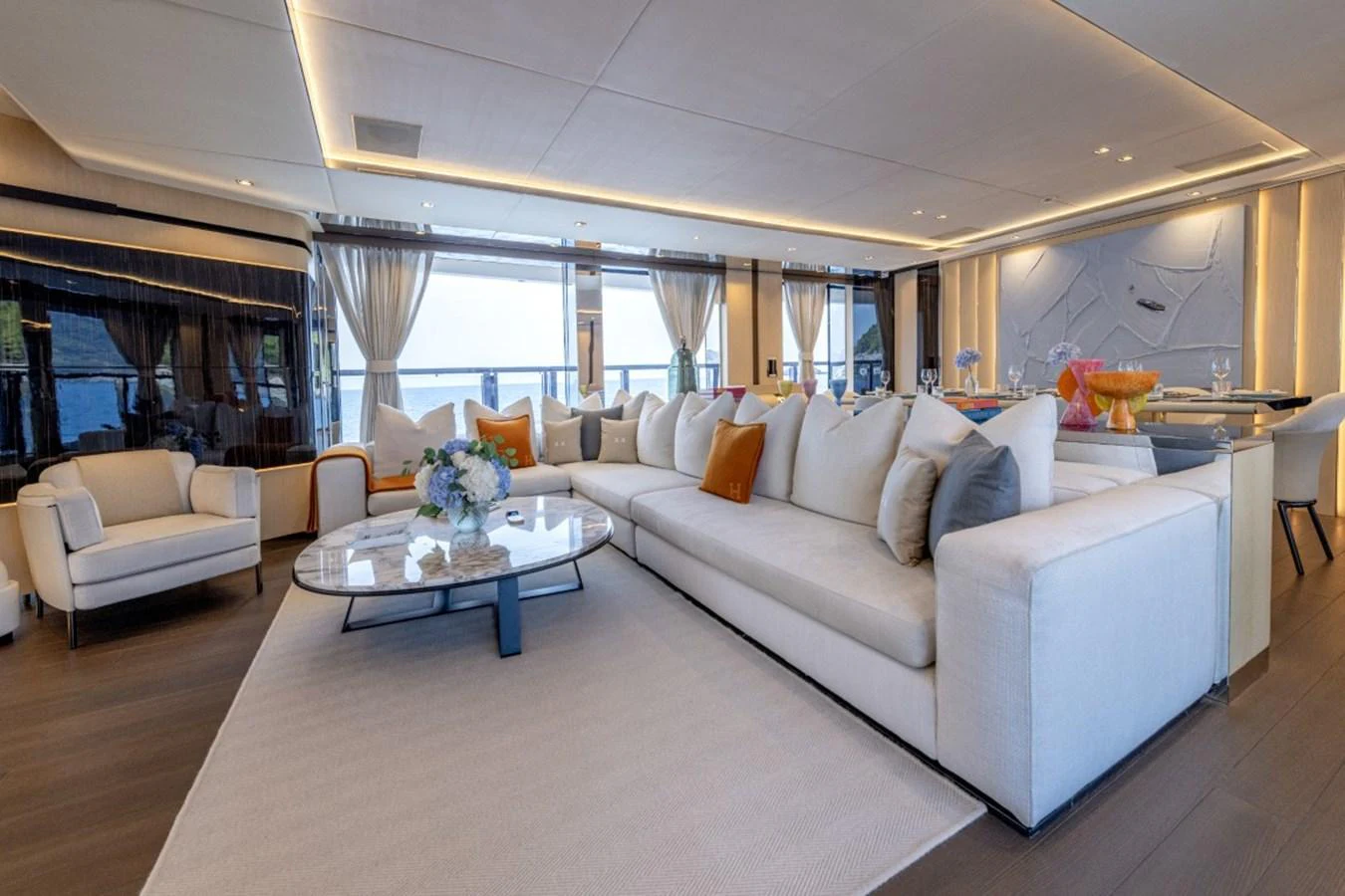 The salon features a spacious seating area with plush sofas and elegant decor. aboard TOY Yacht for Sale