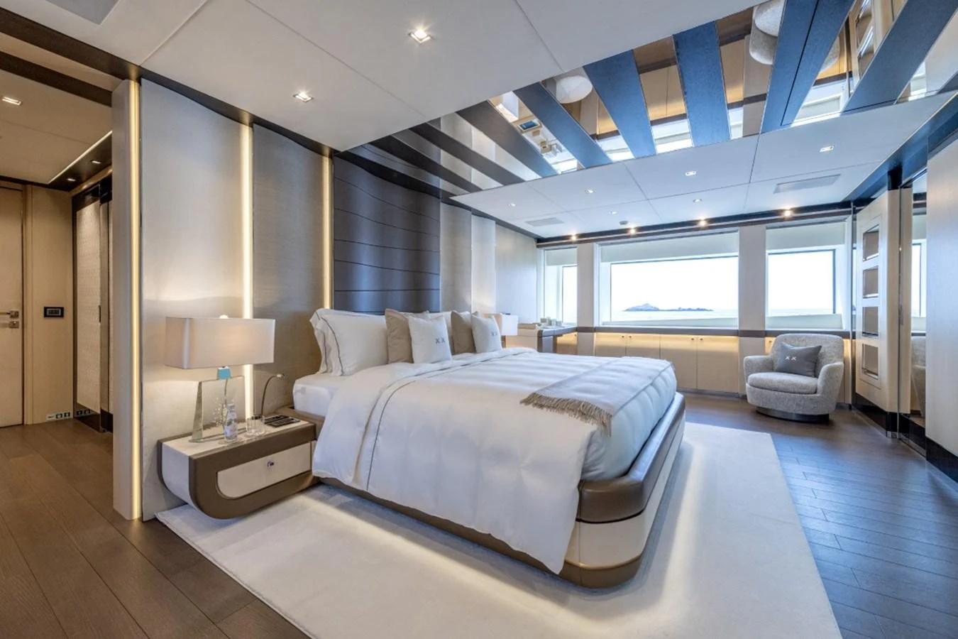The master stateroom features a luxurious bed with elegant decor and ample natural light. aboard TOY Yacht for Sale
