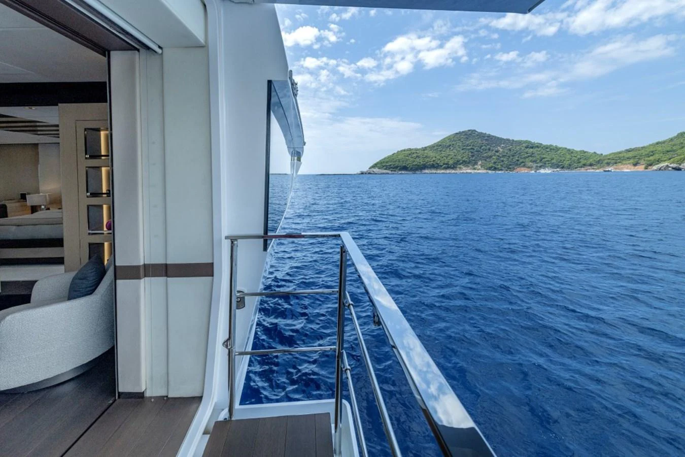 The side deck offers a serene view of the open sea and distant islands. aboard TOY Yacht for Sale