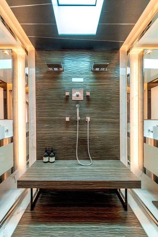 The yacht's shower features a sleek, modern design with luxurious fixtures and ambient lighting. aboard TOY Yacht for Sale