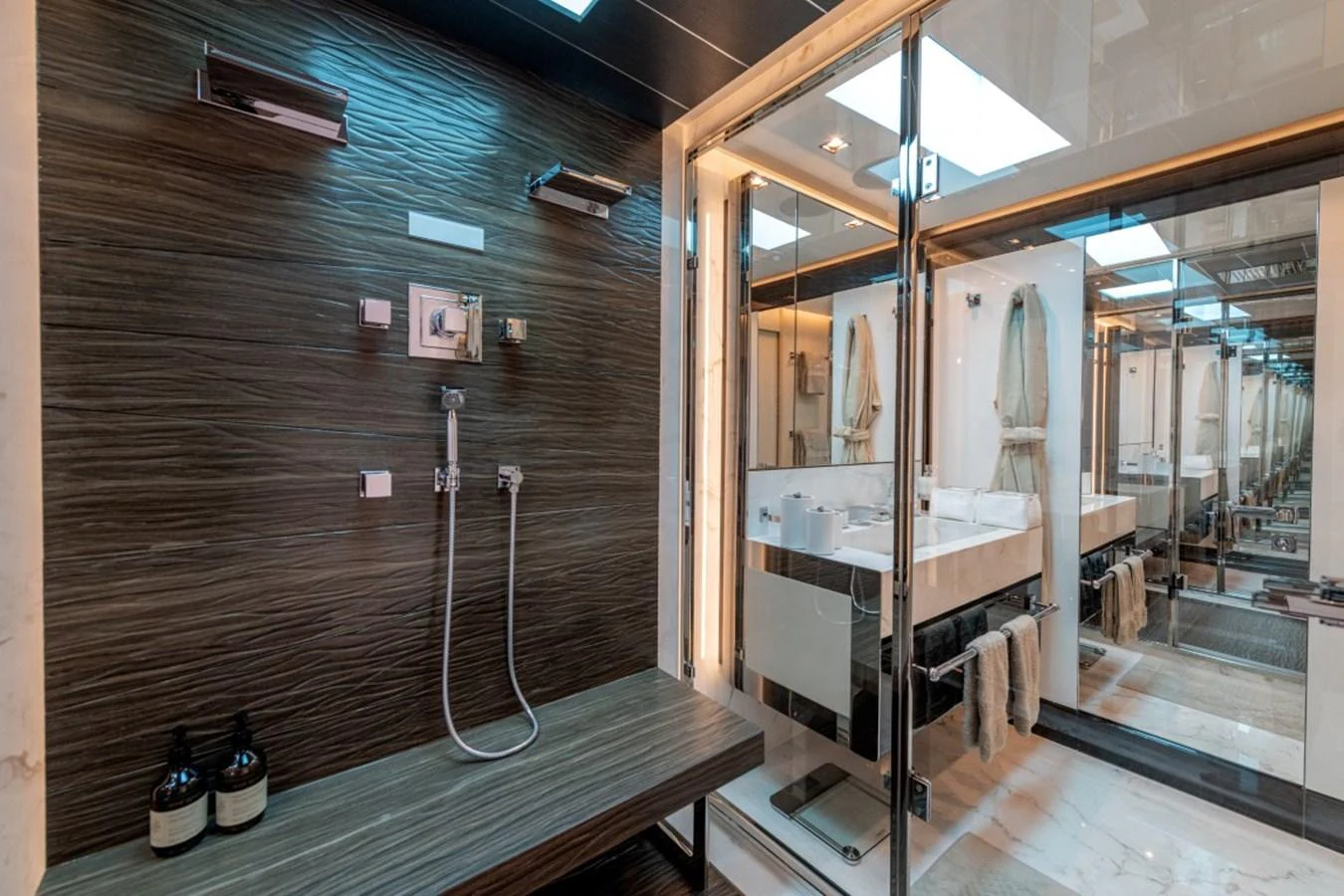 The yacht's bathroom features a modern design with sleek fixtures and a spacious shower area. aboard TOY Yacht for Sale