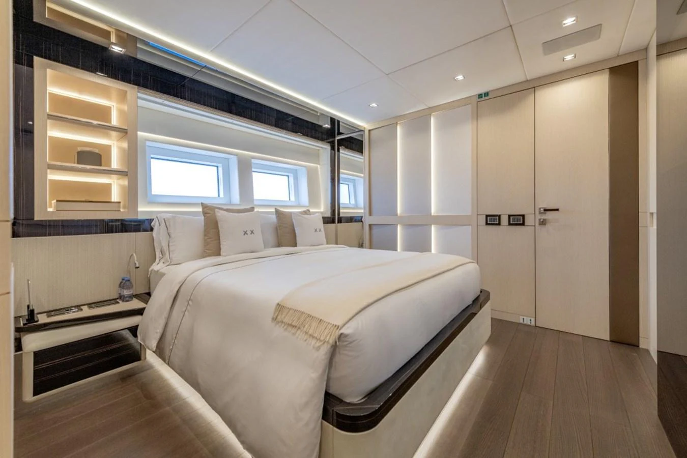 The stateroom features a luxurious bed with modern lighting and ample storage space. aboard TOY Yacht for Sale