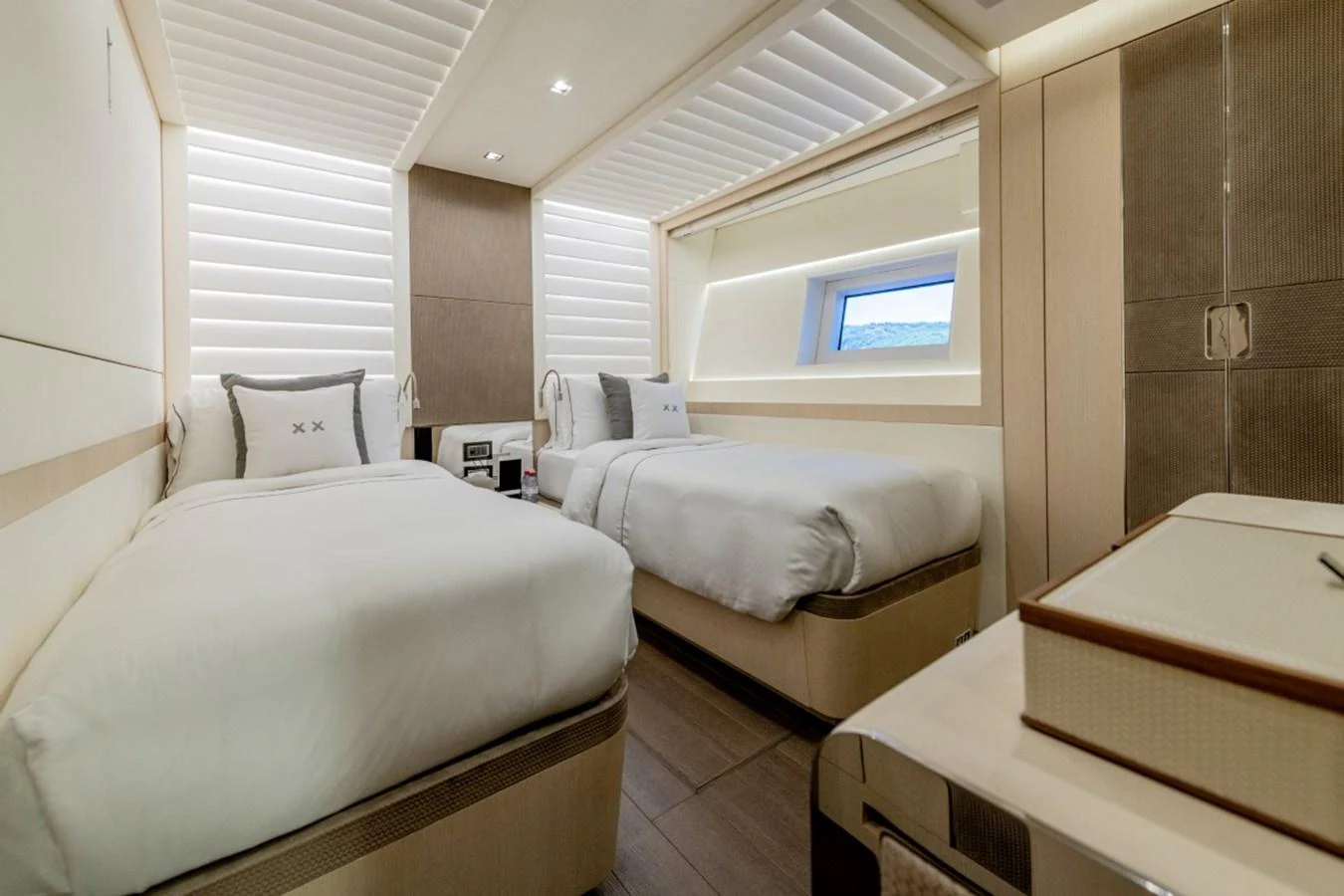 The guest stateroom features twin beds and a modern, elegant design with ample natural light. aboard TOY Yacht for Sale