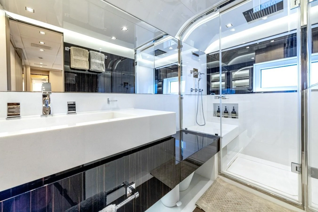 The bathroom features a sleek, modern design with a spacious shower and elegant fixtures. aboard TOY Yacht for Sale