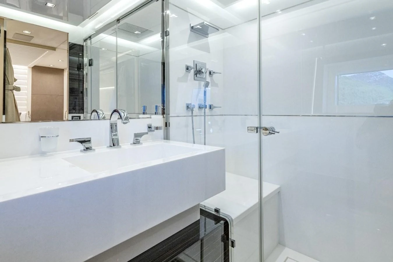 The yacht's bathroom features a sleek, modern design with glass shower enclosures and contemporary fixtures. aboard TOY Yacht for Sale