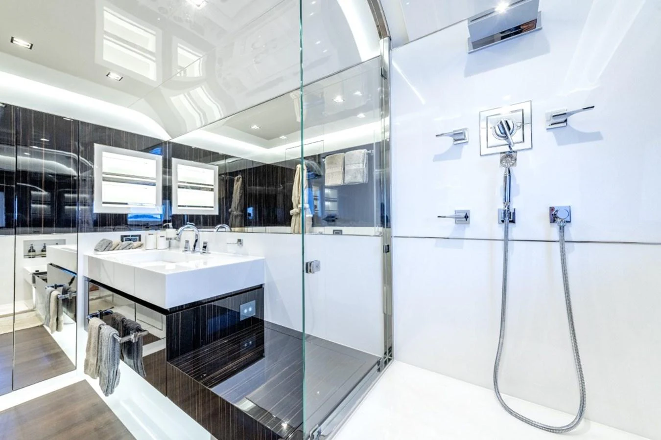 The yacht's bathroom features a sleek, modern design with high-end fixtures and ample lighting. aboard TOY Yacht for Sale