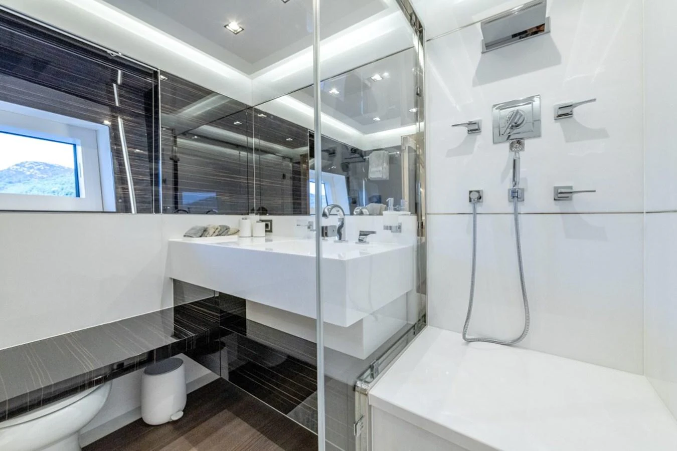 The yacht's bathroom features modern fixtures and a sleek design with a spacious shower area. aboard TOY Yacht for Sale