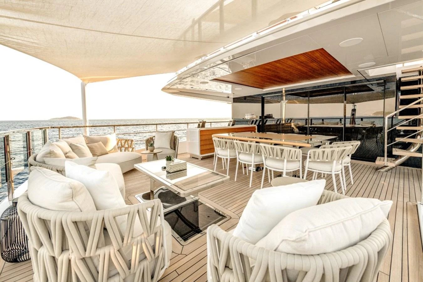 The aft deck offers a luxurious outdoor seating and dining area with a stunning ocean view. aboard TOY Yacht for Sale
