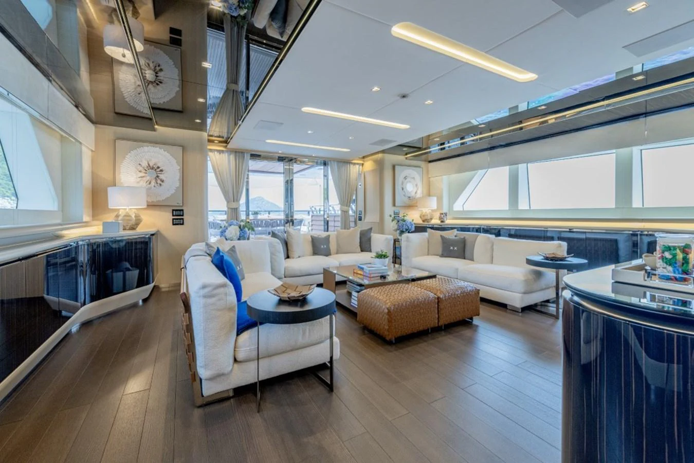 The salon offers a spacious and elegantly designed living area with ample natural light and luxurious furnishings. aboard TOY Yacht for Sale