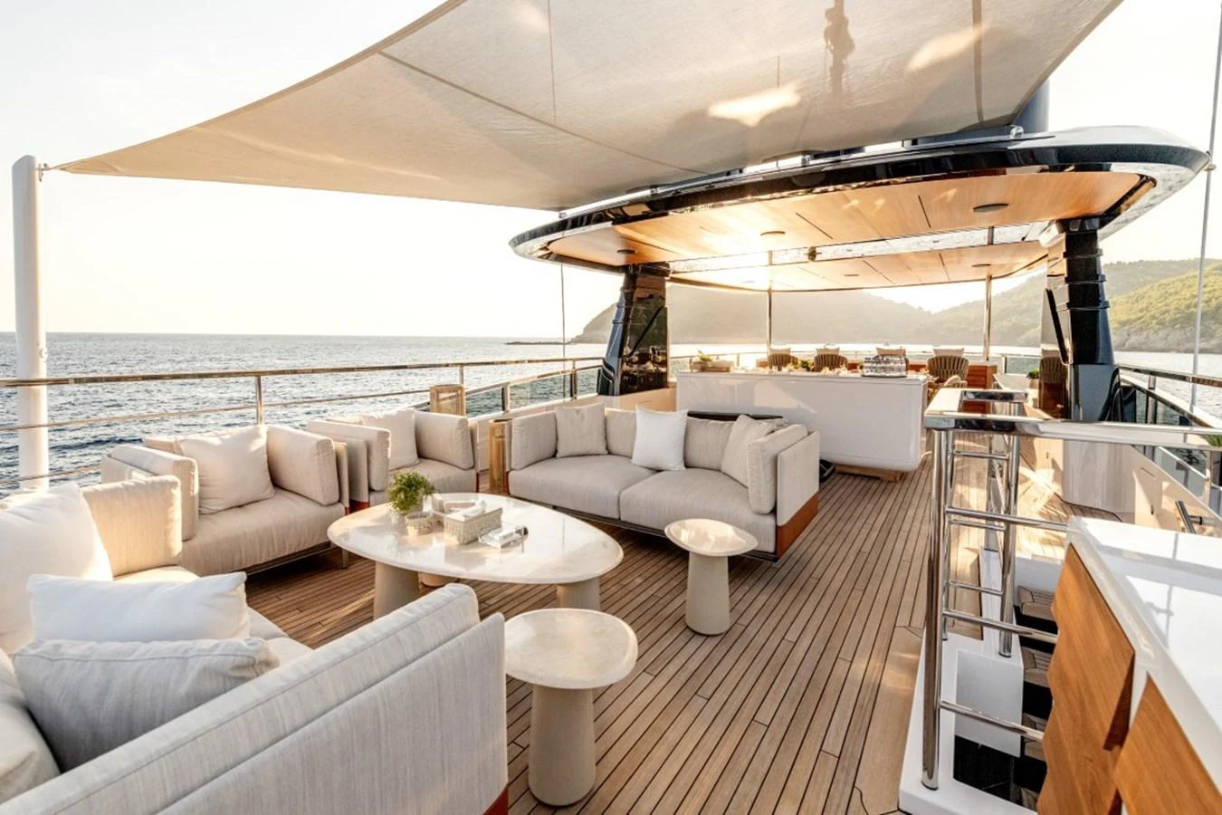 The aft deck offers a luxurious outdoor lounge area with ample seating and stunning ocean views. aboard TOY Yacht for Sale