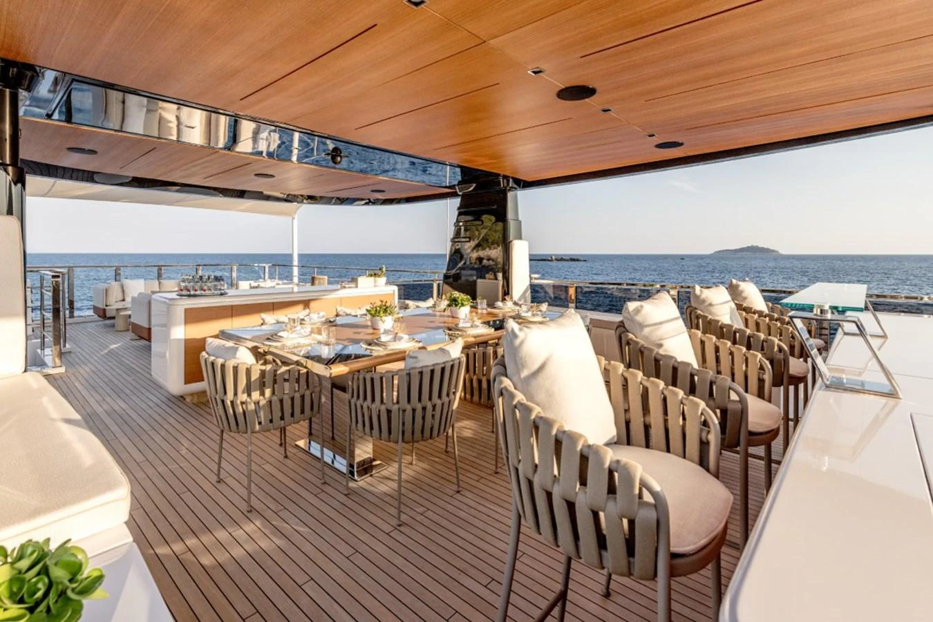 The aft deck features an elegant dining area with a stunning ocean view. aboard TOY Yacht for Sale