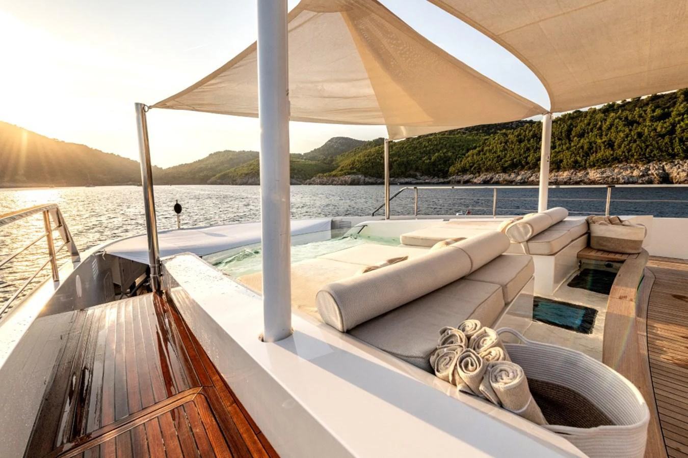 The sundeck features a luxurious lounging area with a jacuzzi and stunning views of the surrounding waters. aboard TOY Yacht for Sale