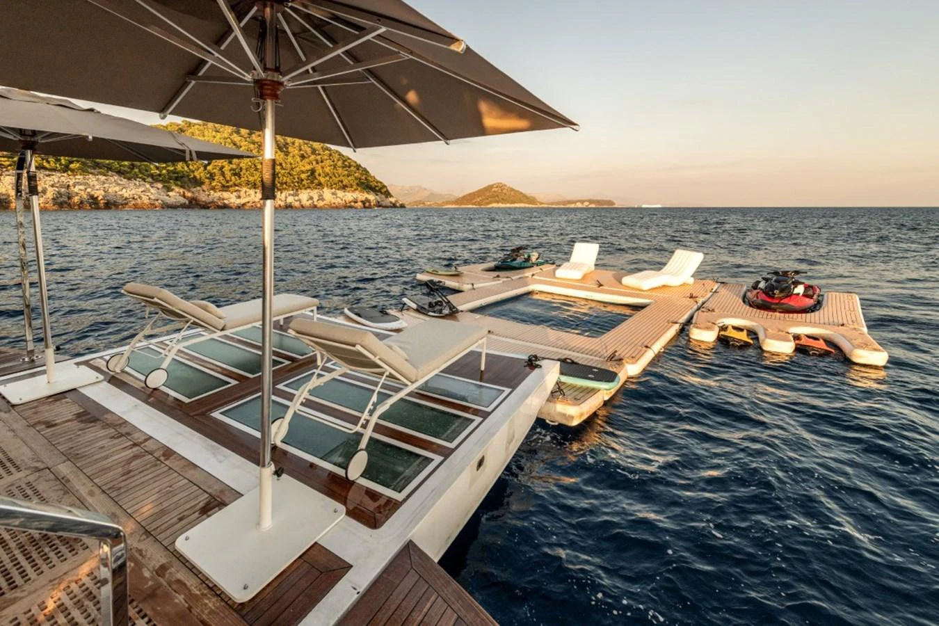 The yacht features an expansive swim platform with sun loungers and water toys, perfect for enjoying the sea. aboard TOY Yacht for Sale