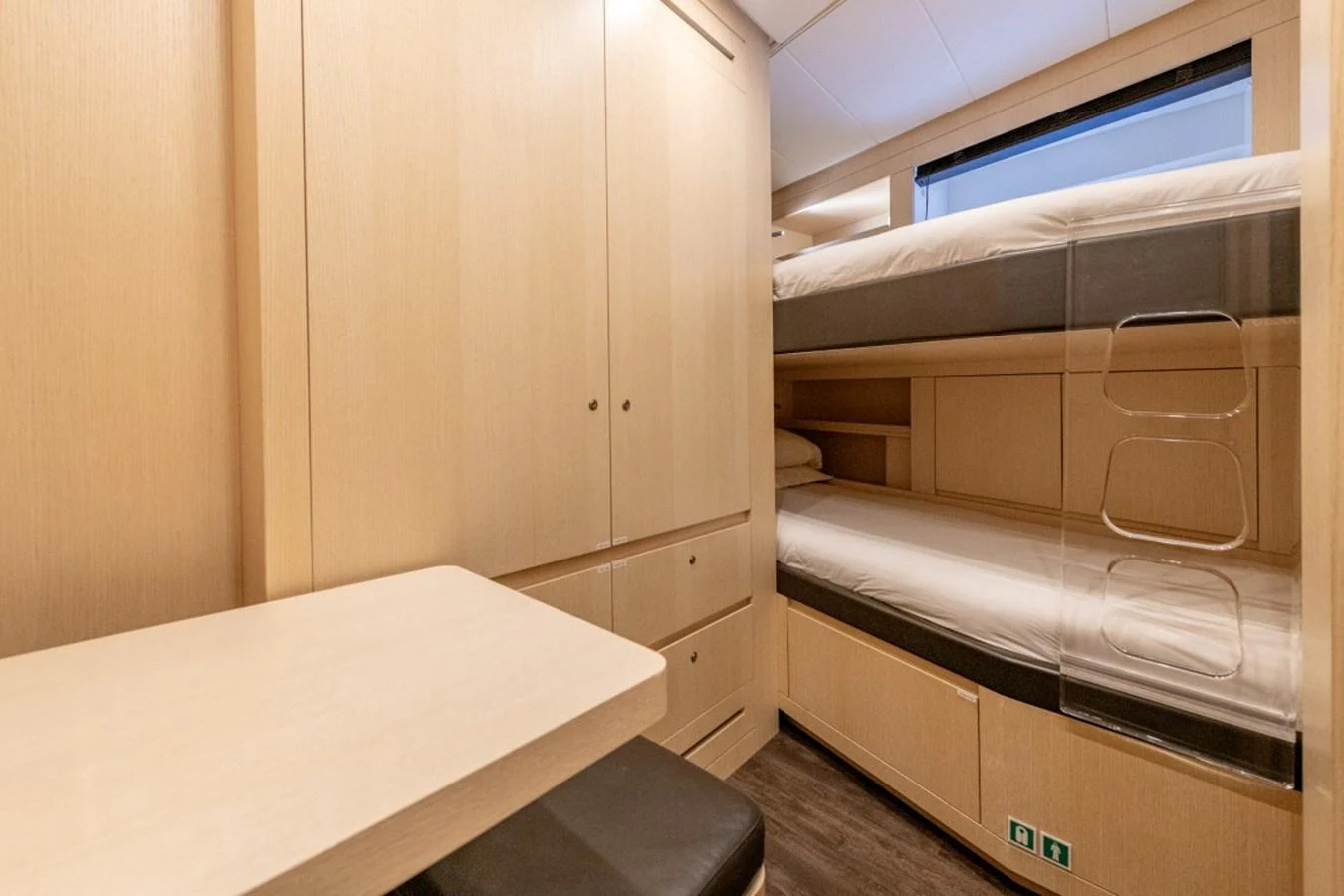 The crew cabin features practical bunk beds and ample storage space in a light wood finish. aboard TOY Yacht for Sale