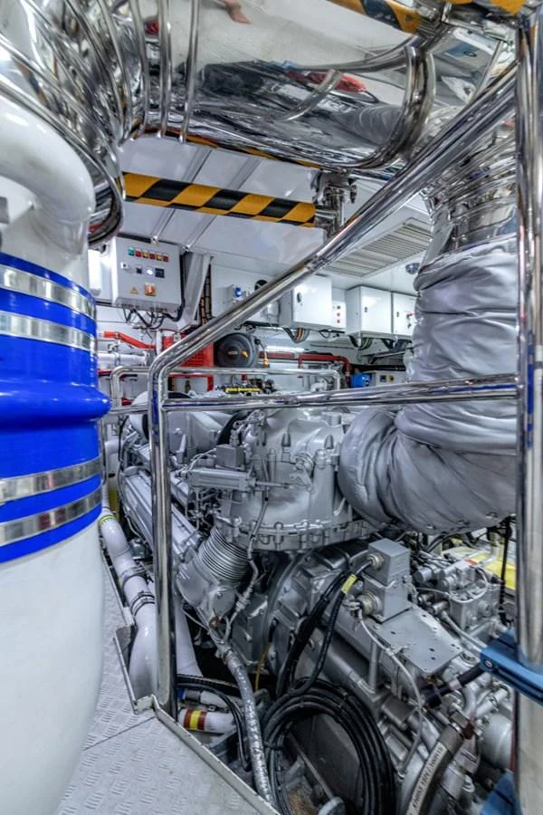 The image showcases the yacht's meticulously maintained engine room with advanced machinery and piping. aboard TOY Yacht for Sale