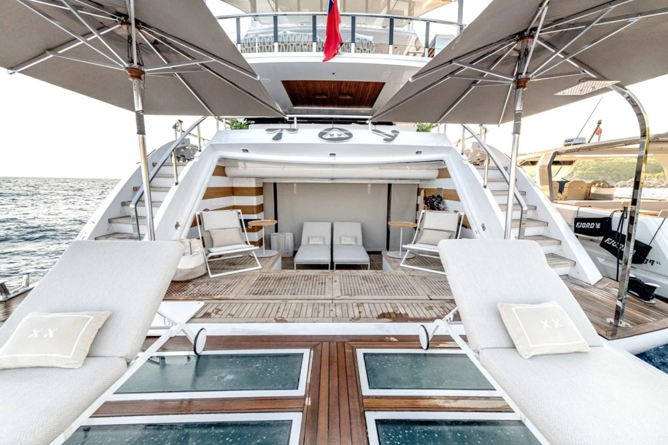 The aft deck features luxurious sun loungers and shaded areas for ultimate relaxation. aboard TOY Yacht for Sale