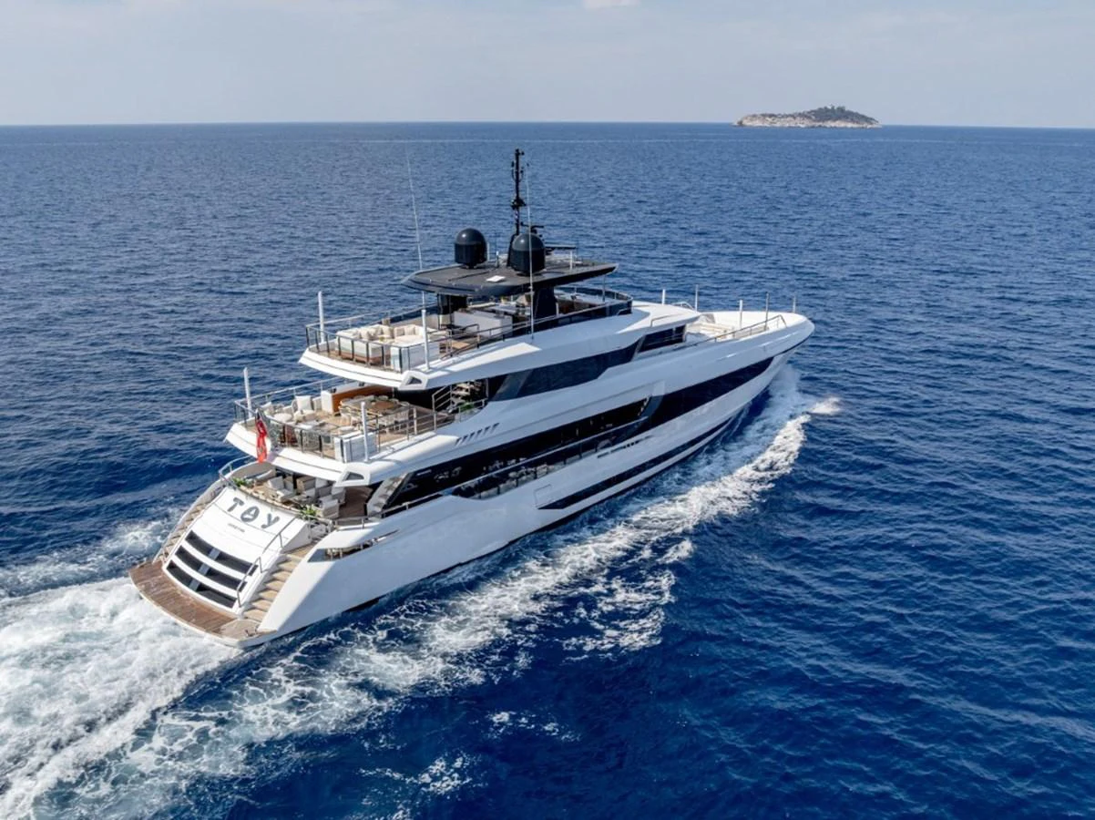 A luxurious yacht cruises through the open sea, showcasing its sleek design and spacious decks. aboard TOY Yacht for Sale